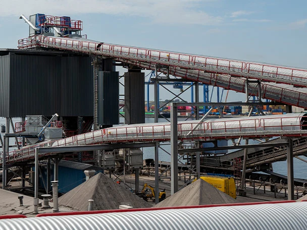 Covers installed on conveyor installation against dust